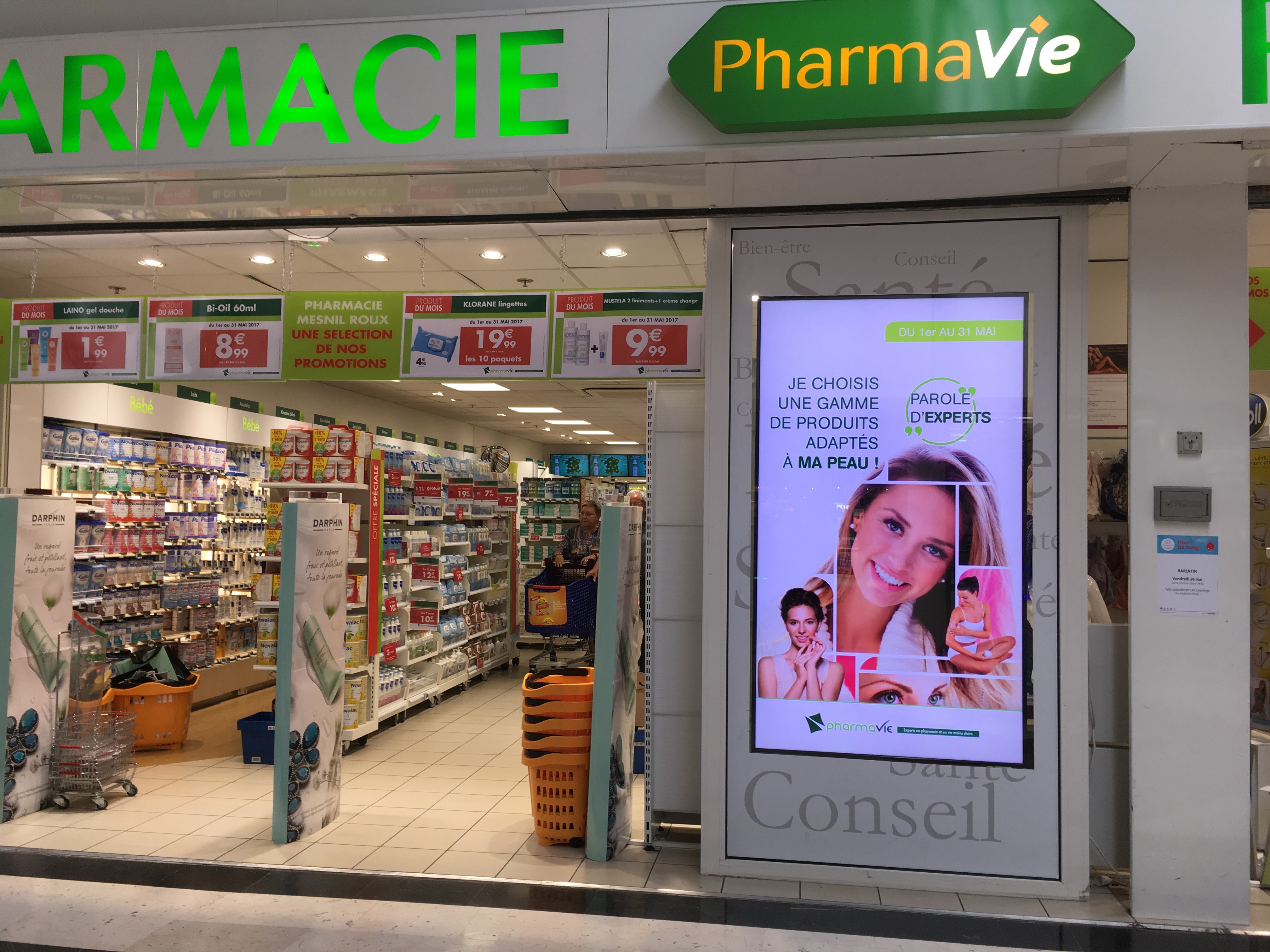 Entrance to a pharmacy with a big digital sign