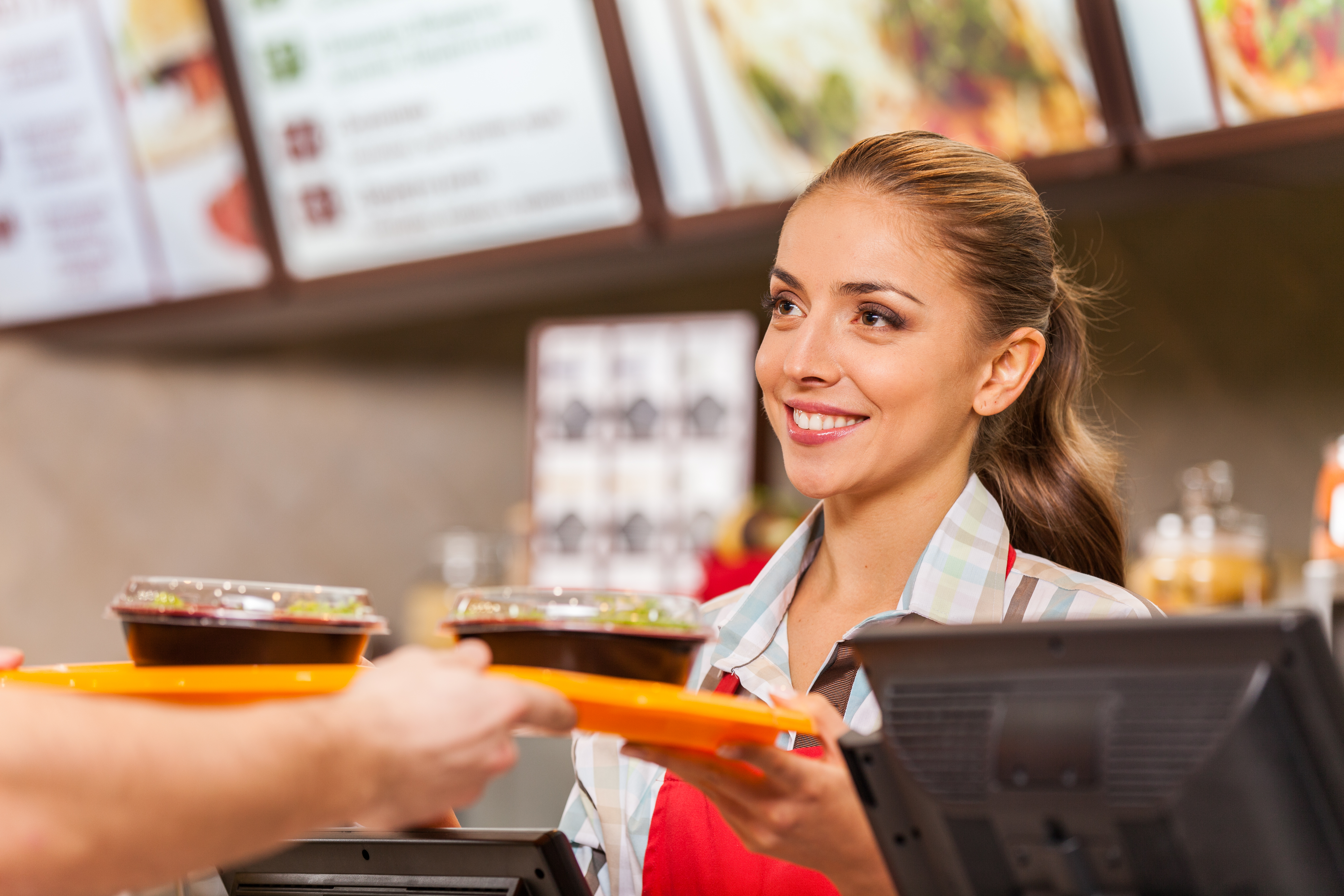 Restaurant Worker Serving Two Fast Food Meals With Smile